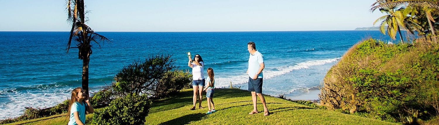 Why Invest in Riviera Nayarit Mexico - image of Family of 4 playing on lawn by the ocean