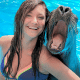 Young girl and sea lion laughing together