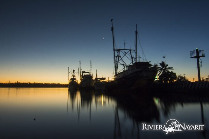 Moored fishing boats at dusk in San Blas Riviera Nayarit Mexico