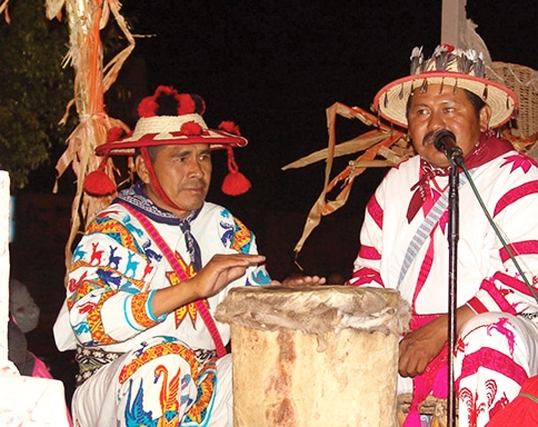 Huicholes culture on display - two men in costumes drumming