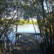 Wooden dock extending through the trees and over the water