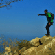 Man pointing out to sea while hiking on the Pacific Coast of Nayarit Mexico