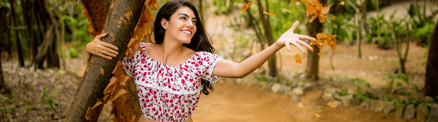 Banner of a young woman tossing leaves