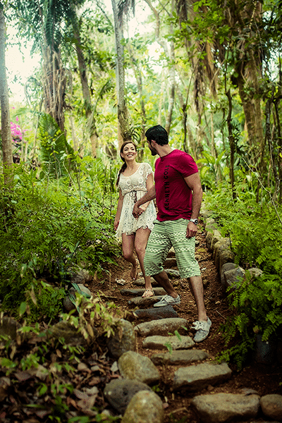 Young couple holding hands while enjoying a rainforest walk