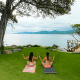 Two woman doing yoga on a lawn beside the Ocean in Sayulita Nayarit